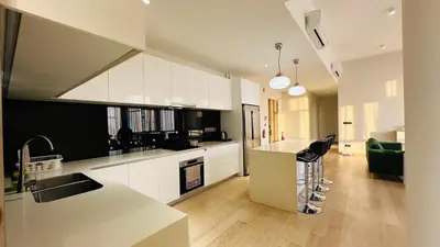 a kitchen with white cabinets and a counter top at Star Residence Suite KLCC in Kuala Lumpur