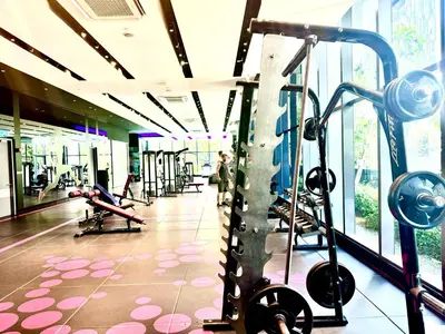 a gym with cardio equipment and people exercising in it at Star Residence Suite KLCC in Kuala Lumpur