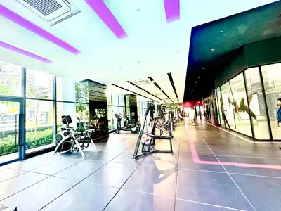 a building with a gym with chairs and windows at Star Residence Suite KLCC in Kuala Lumpur