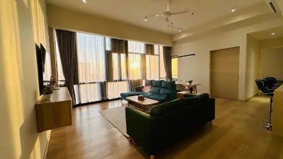 a living room with a couch and a table at Star Residence Suite KLCC in Kuala Lumpur