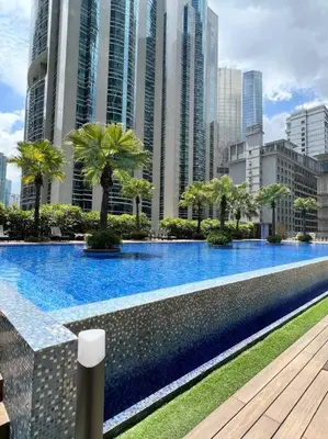 a large swimming pool in a city with tall buildings at 450m from Aquaria KLCC/KL ConventionCtre, 2 Beds#2 in Kuala Lumpur