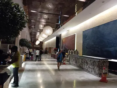 a group of people walking down a hallway in a building at Platinum suites klcc by Fifty One in Kuala Lumpur