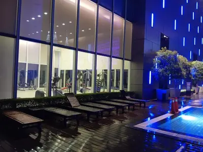 a row of benches in a building with a pool at Platinum suites klcc by Fifty One in Kuala Lumpur