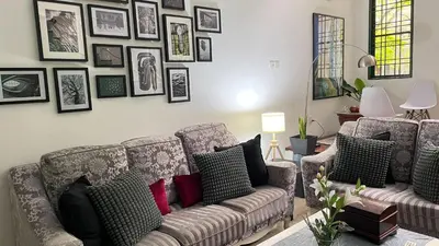 a living room with a couch and pictures on the wall at Townhouse in KLCC Vicinity in Kuala Lumpur