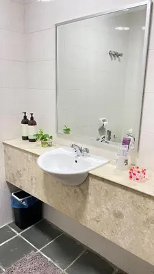 a bathroom counter with a sink and a mirror at Townhouse in KLCC Vicinity in Kuala Lumpur