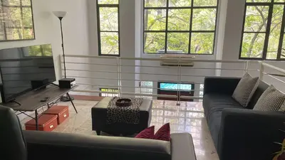 a living room with a couch and a table at Townhouse in KLCC Vicinity in Kuala Lumpur