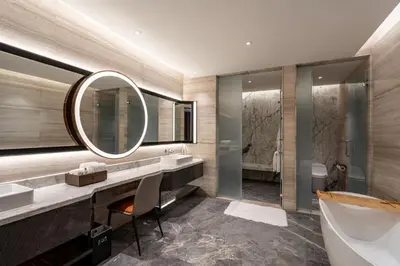 a bathroom with a tub and a sink and a mirror at Imperial Lexis Kuala Lumpur in Kuala Lumpur