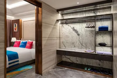 a bedroom with a shower and a bed and a tub at Imperial Lexis Kuala Lumpur in Kuala Lumpur