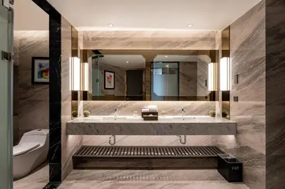 a bathroom with a sink and a toilet and a mirror at Imperial Lexis Kuala Lumpur in Kuala Lumpur