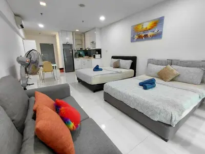 a living room with a couch and a bed at KLCC Summer Suite#3, Monorail, 4Pax in Kuala Lumpur