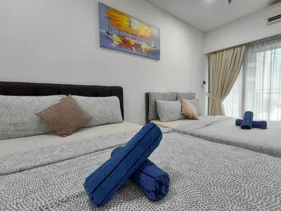 a living room with two beds with blue objects on the floor at KLCC Summer Suite#3, Monorail, 4Pax in Kuala Lumpur