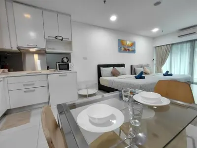 a kitchen and a living room with a table and a bed at KLCC Summer Suite#3, Monorail, 4Pax in Kuala Lumpur