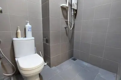 a bathroom with a toilet and a shower with a phone at KLCC Summer Suite#3, Monorail, 4Pax in Kuala Lumpur