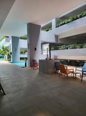 a patio with chairs and tables in a building at Neu Suite Ampang, LRT Jelatek, Gleneagles Hospital in Kuala Lumpur