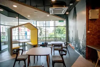 a restaurant with tables and chairs and a large window at Neu Suite Ampang, LRT Jelatek, Gleneagles Hospital in Kuala Lumpur