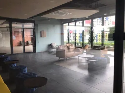 a lobby with a couch and tables and windows at Neu Suite Ampang, LRT Jelatek, Gleneagles Hospital in Kuala Lumpur