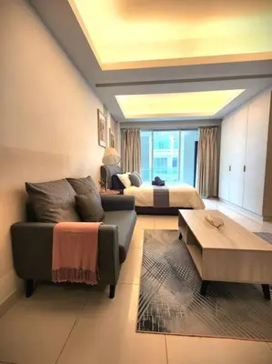 a living room with a couch and a bed at KL Dorsett Damas Urban Garden Suite-F-Parking, Self C-In in Kuala Lumpur