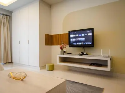 a living room with a flat screen tv on a wall at KL Dorsett Damas Urban Garden Suite-F-Parking, Self C-In in Kuala Lumpur