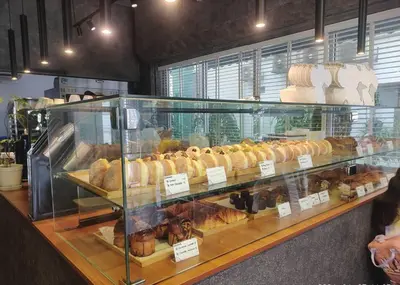 a display case filled with lots of different types of pastries at KL Dorsett Damas Urban Garden Suite-F-Parking, Self C-In in Kuala Lumpur