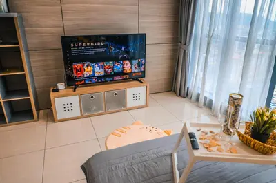 a living room with a tv and a couch at M CITY Near KLCC KPJ Puteri Specialist Hospital in Kuala Lumpur