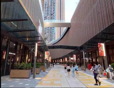 a group of people walking down a street in a city at Maxhome Premium at Lucentia Bukit Bintang City Centre KL in Kuala Lumpur