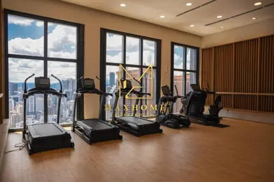 a gym with treadmills and exercise equipment in a building at Maxhome Premium at Lucentia Bukit Bintang City Centre KL in Kuala Lumpur