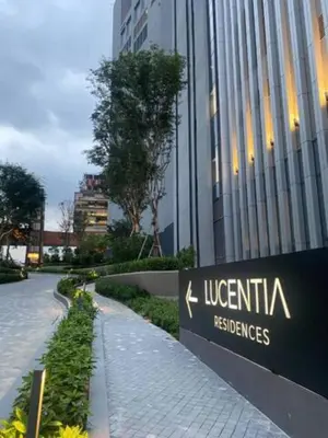 a sign in front of a building in a city at Maxhome Premium at Lucentia Bukit Bintang City Centre KL in Kuala Lumpur