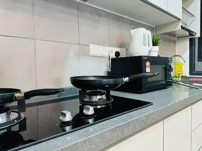 a kitchen with a stove with a pan on it at MVC30#Family Suite 8pax 3 Rooms Sunway Velocity Mall Cheras IKEA Mytown Short Walk to MRT & LRT Maluri in Kuala Lumpur
