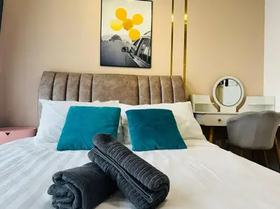a bed with two blue pillows on top of it at MVC30#Family Suite 8pax 3 Rooms Sunway Velocity Mall Cheras IKEA Mytown Short Walk to MRT & LRT Maluri in Kuala Lumpur