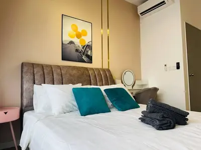 a bedroom with a white bed with two blue pillows at MVC30#Family Suite 8pax 3 Rooms Sunway Velocity Mall Cheras IKEA Mytown Short Walk to MRT & LRT Maluri in Kuala Lumpur