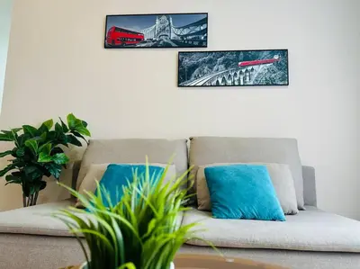 a couch with two blue pillows in a living room at MVC30#Family Suite 8pax 3 Rooms Sunway Velocity Mall Cheras IKEA Mytown Short Walk to MRT & LRT Maluri in Kuala Lumpur
