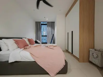 a bedroom with a bed with a pink blanket on it at Arcoris Mont Kiara 18# Sunway 163 Mall# 1 Mont Kiara # 2 BR with Balcony 2-4 Pax in Kuala Lumpur