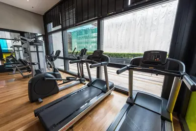 a gym with two tread machines and a window at Arcoris Mont Kiara 18# Sunway 163 Mall# 1 Mont Kiara # 2 BR with Balcony 2-4 Pax in Kuala Lumpur