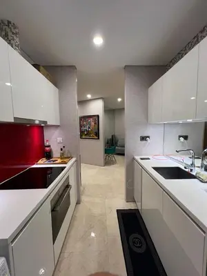 a kitchen with white cabinets and a sink and a stove at Vortex KLCC (42) Amazing view in Kuala Lumpur