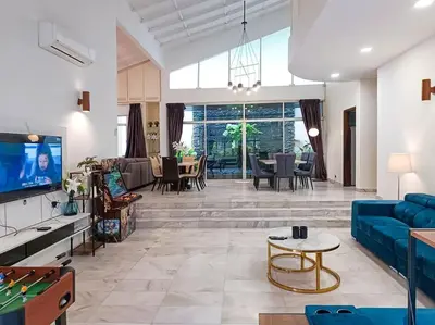a living room with a blue couch and a tv at KL Secret Karaoke Private Pool Villa in Ampang