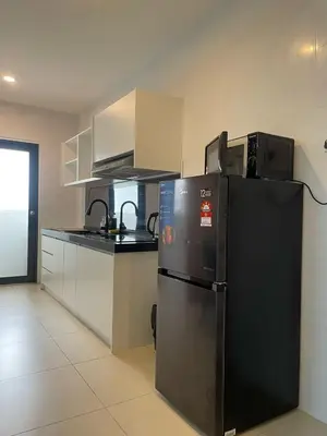 a kitchen with a black refrigerator and a sink at Reizz Residence By Sweet Home in Kuala Lumpur