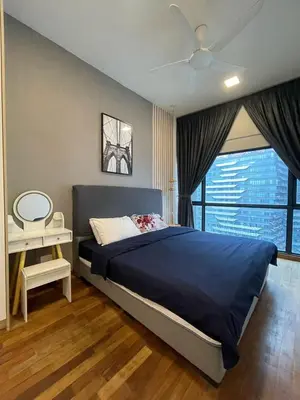 a bedroom with a large blue bed with a window at Reizz Residence By Sweet Home in Kuala Lumpur