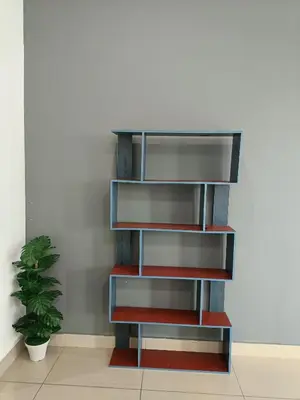 a book shelf in a room with a plant at Arte Plus by Stay Relax in Kuala Lumpur