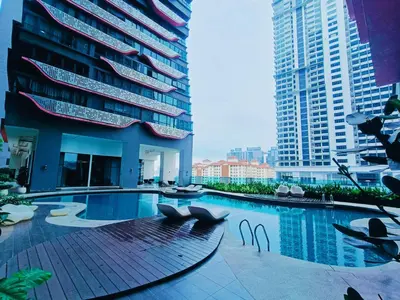 a swimming pool in a city with tall buildings at Arte Plus by Stay Relax in Kuala Lumpur