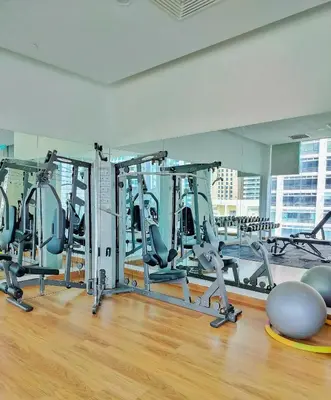 a gym with several tread machines in a room at Lila House One Bukit Ceylon in Kuala Lumpur