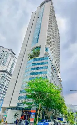 a tall building with a tree in front of it at Lila House One Bukit Ceylon in Kuala Lumpur