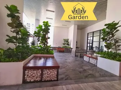 a lobby with benches and plants in a building at Chambers A Studio Flat, KLCC & KL Tower view, City in Kuala Lumpur