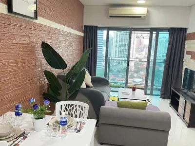 a living room with a brick wall at Mercu summer suites By Premium Charter in Kuala Lumpur