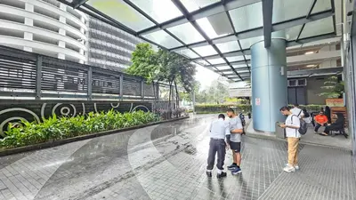 a group of people standing inside of a building at Mercu summer suites By Premium Charter in Kuala Lumpur