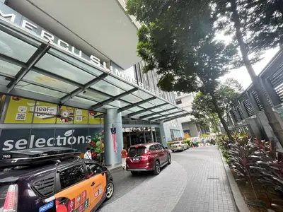a red car parked in front of a building at Mercu summer suites By Premium Charter in Kuala Lumpur