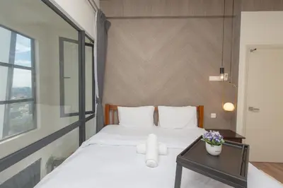 a bedroom with a white bed and a table at Arte Mont Kiara by MY TRIP & MY STAY in Kuala Lumpur