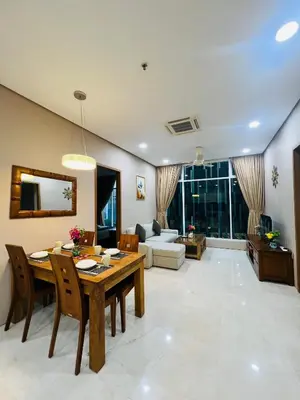 a living room with a dining table and a couch at Soho Suites KLCC by Comfort Suites Kuala Lumpur in Kuala Lumpur