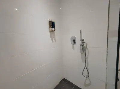 a white bathroom with a phone on the wall at Arcoris Mont Kiara 2# Sunway 163# 2-Bedroom with balcony 2-4Pax in Kuala Lumpur