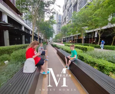 a woman and two children sitting on a park bench at Arcoris Mont Kiara 2# Sunway 163# 2-Bedroom with balcony 2-4Pax in Kuala Lumpur