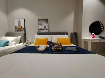 a bedroom with a large bed with yellow and blue pillows at Arcoris Mont Kiara 19#Main Street# Walking Distance 1MK# 1BR 1-3Pax in Kuala Lumpur